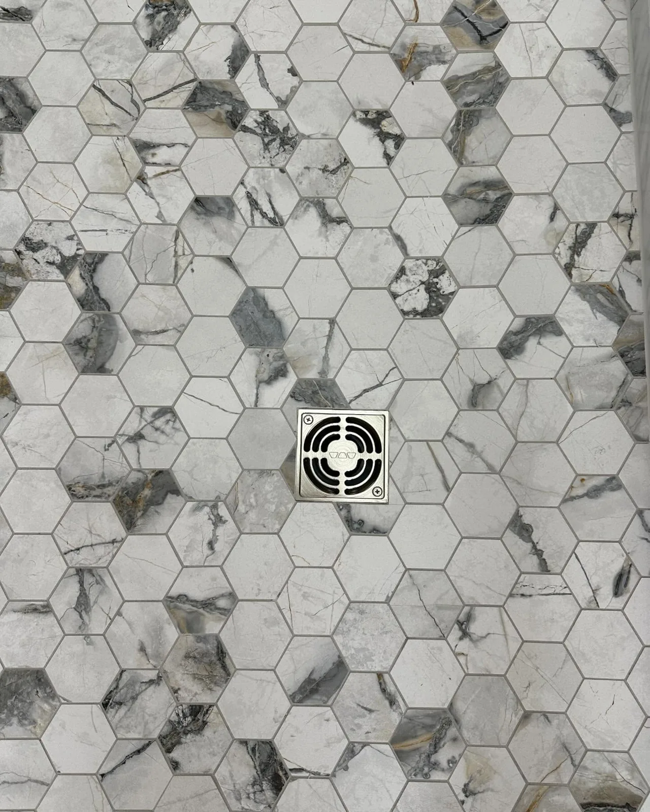 Hexagon marble mosaic shower floor with drain