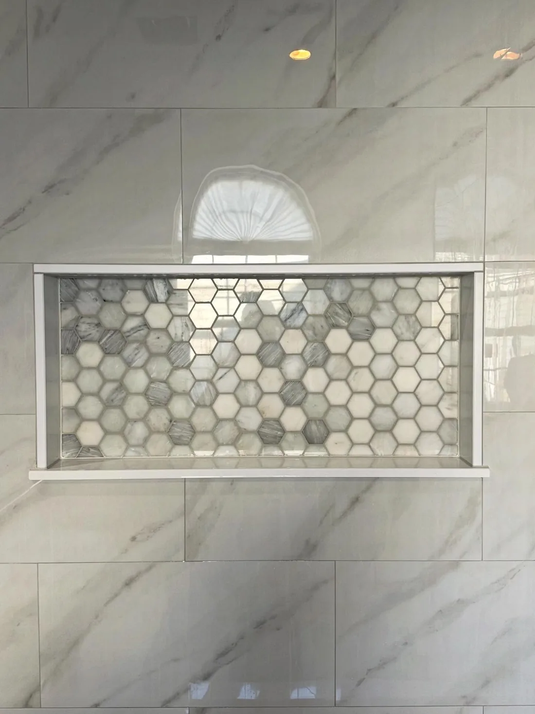 Shower niche with hexagon mosaic tile