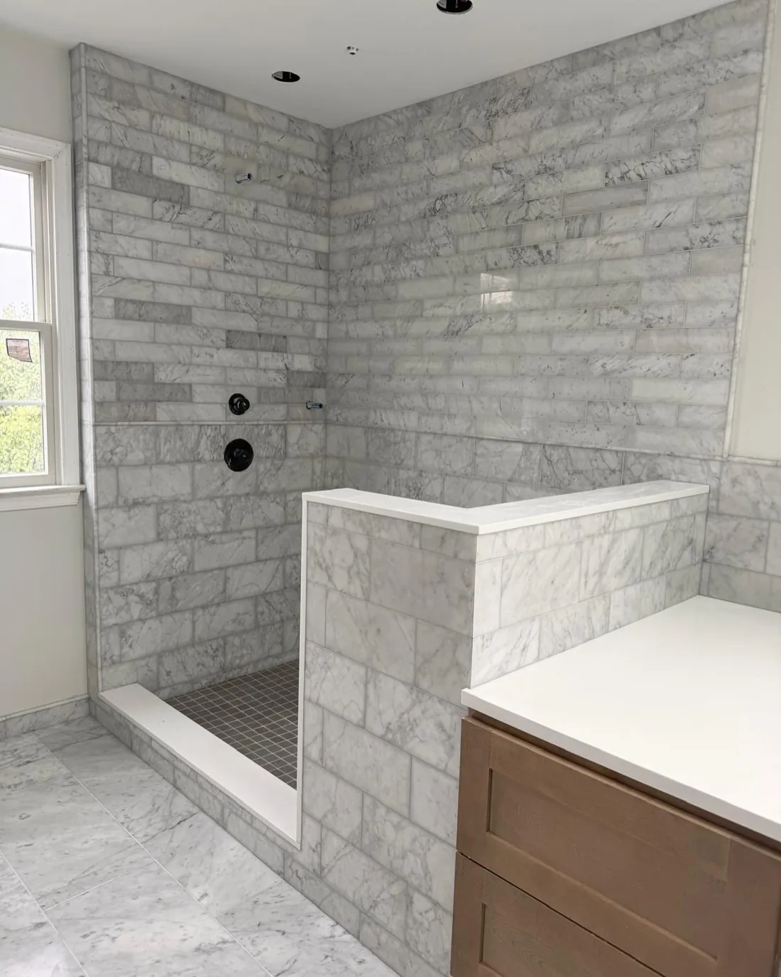 Marble subway tile shower and bathroom floor.