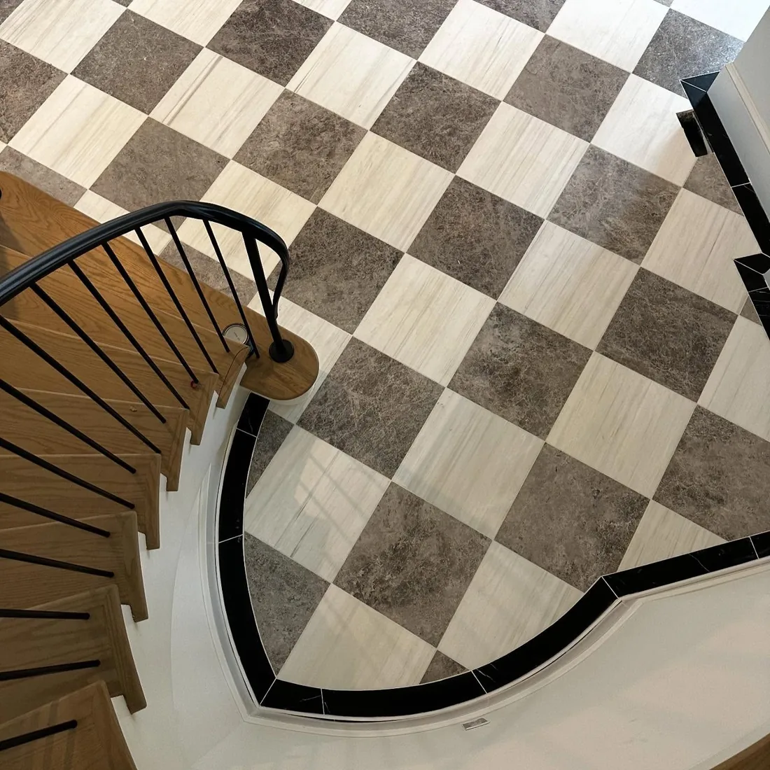 Checkered marble tile floor with wood staircase.