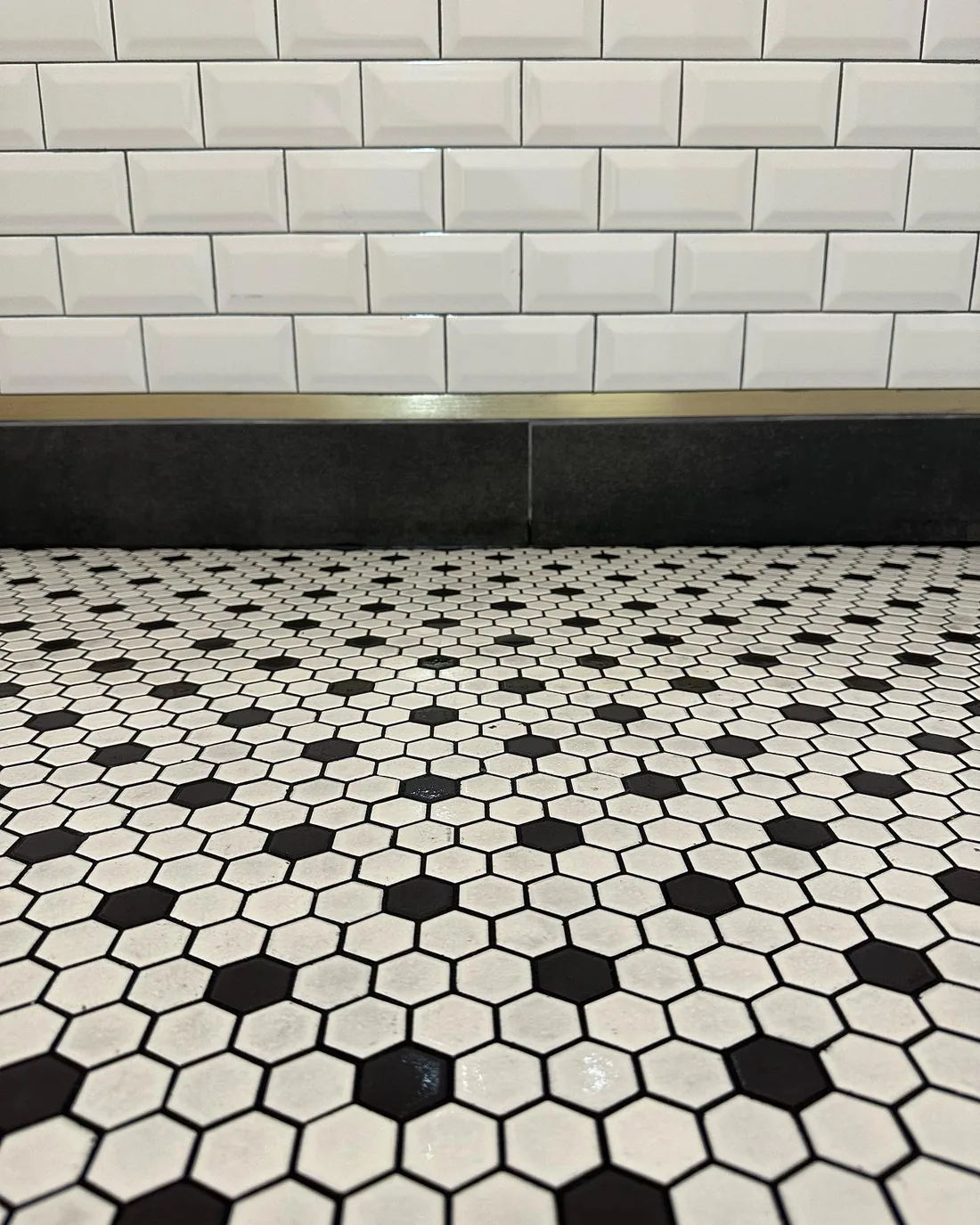 Black and white hexagon floor and subway tile